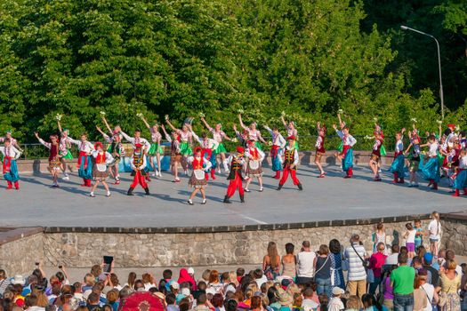 KIEV, UKRAINE - July 22 , 2016: Ukraina School of Dance Ensemble girls and boys dressed in traditional red Ukrainian embroidered costume clothes dancing