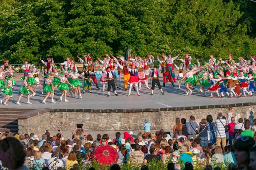 KIEV, UKRAINE - July 22 , 2016: Ukraina School of Dance Ensemble girls and boys dressed in traditional red Ukrainian embroidered costume clothes dancing