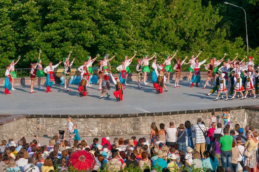 KIEV, UKRAINE - July 22 , 2016: Ukraina School of Dance Ensemble girls and boys dressed in traditional red Ukrainian embroidered costume clothes dancing
