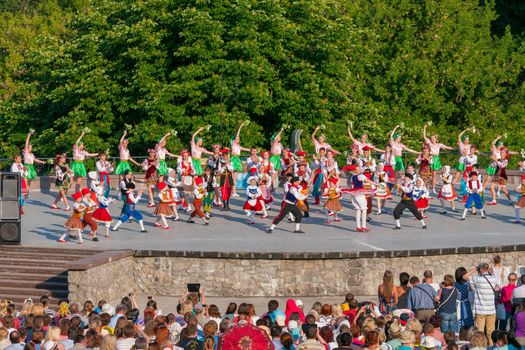 KIEV, UKRAINE - July 22 , 2016: Ukraina School of Dance Ensemble girls and boys dressed in traditional red Ukrainian embroidered costume clothes dancing