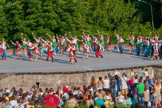KIEV, UKRAINE - July 22 , 2016: Ukraina School of Dance Ensemble girls and boys dressed in traditional red Ukrainian embroidered costume clothes dancing