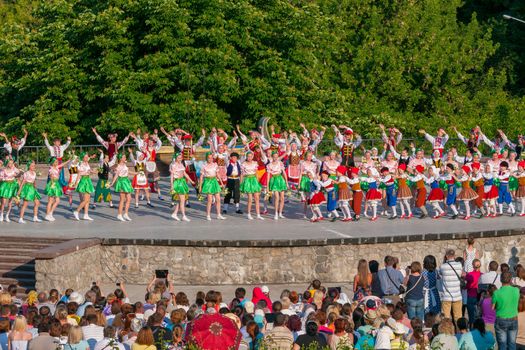 KIEV, UKRAINE - July 22 , 2016: Ukraina School of Dance Ensemble girls and boys dressed in traditional red Ukrainian embroidered costume clothes dancing