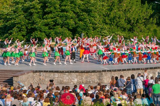 KIEV, UKRAINE - July 22 , 2016: Ukraina School of Dance Ensemble girls and boys dressed in traditional red Ukrainian embroidered costume clothes dancing