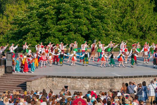 KIEV, UKRAINE - July 22 , 2016: Ukraina School of Dance Ensemble girls and boys dressed in traditional red Ukrainian embroidered costume clothes dancing