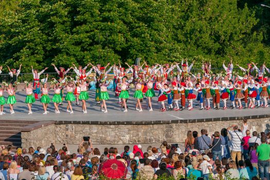 KIEV, UKRAINE - July 22 , 2016: Ukraina School of Dance Ensemble girls and boys dressed in traditional red Ukrainian embroidered costume clothes dancing