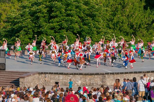 KIEV, UKRAINE - July 22 , 2016: Ukraina School of Dance Ensemble girls and boys dressed in traditional red Ukrainian embroidered costume clothes dancing