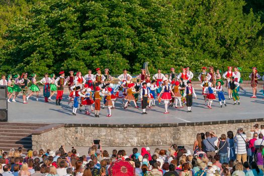 KIEV, UKRAINE - July 22 , 2016: Ukraina School of Dance Ensemble girls and boys dressed in traditional red Ukrainian embroidered costume clothes dancing