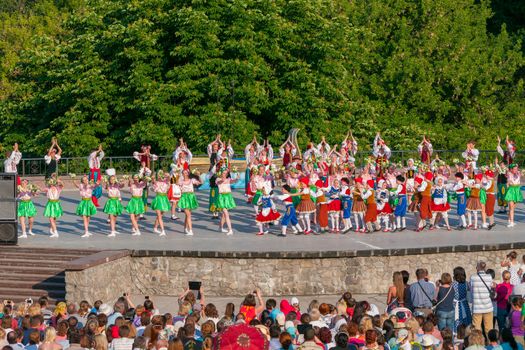 KIEV, UKRAINE - July 22 , 2016: Ukraina School of Dance Ensemble girls and boys dressed in traditional red Ukrainian embroidered costume clothes dancing