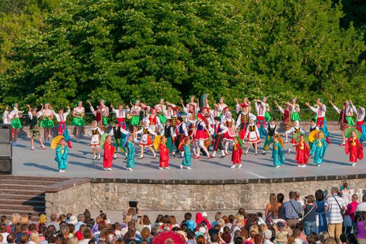 KIEV, UKRAINE - July 22 , 2016: Ukraina School of Dance Ensemble girls and boys dressed in traditional red Ukrainian embroidered costume clothes dancing