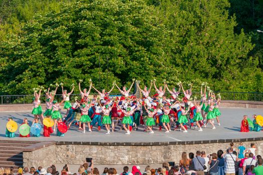 KIEV, UKRAINE - July 22 , 2016: Ukraina School of Dance Ensemble girls and boys dressed in traditional red Ukrainian embroidered costume clothes dancing