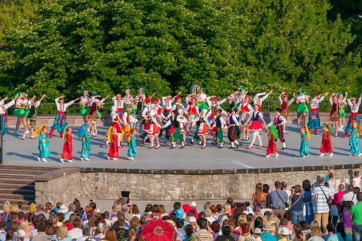 KIEV, UKRAINE - July 22 , 2016: Ukraina School of Dance Ensemble girls and boys dressed in traditional red Ukrainian embroidered costume clothes dancing