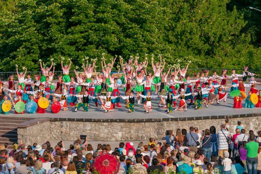 KIEV, UKRAINE - July 22 , 2016: Ukraina School of Dance Ensemble girls and boys dressed in traditional red Ukrainian embroidered costume clothes dancing