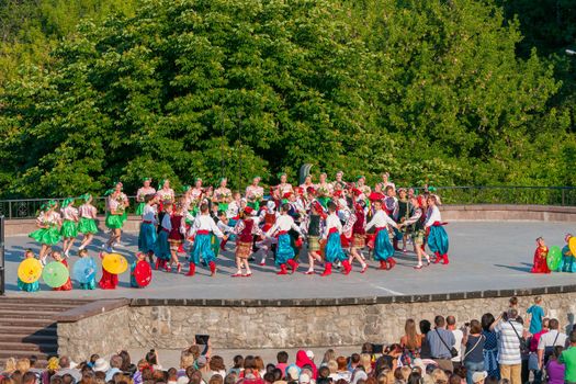 KIEV, UKRAINE - July 22 , 2016: Ukraina School of Dance Ensemble girls and boys dressed in traditional red Ukrainian embroidered costume clothes dancing