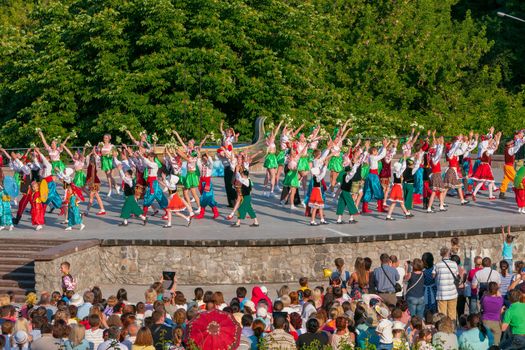 KIEV, UKRAINE - July 22 , 2016: Ukraina School of Dance Ensemble girls and boys dressed in traditional red Ukrainian embroidered costume clothes dancing