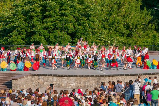 KIEV, UKRAINE - July 22 , 2016: Ukraina School of Dance Ensemble girls and boys dressed in traditional red Ukrainian embroidered costume clothes dancing