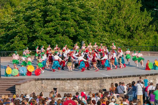 KIEV, UKRAINE - July 22 , 2016: Ukraina School of Dance Ensemble girls and boys dressed in traditional red Ukrainian embroidered costume clothes dancing