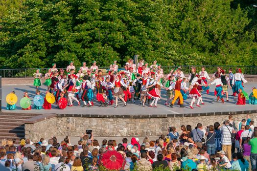 KIEV, UKRAINE - July 22 , 2016: Ukraina School of Dance Ensemble girls and boys dressed in traditional red Ukrainian embroidered costume clothes dancing