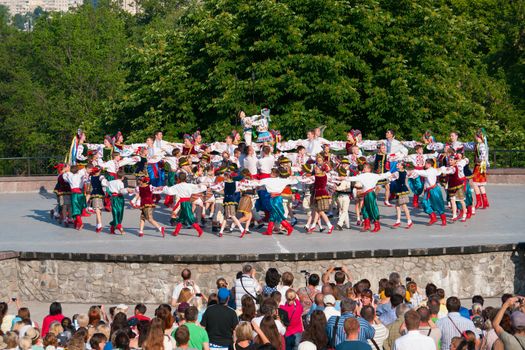 KIEV, UKRAINE - July 22 , 2016: Ukraina School of Dance Ensemble girls and boys dressed in traditional red Ukrainian embroidered costume clothes dancing