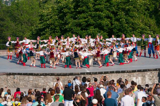 KIEV, UKRAINE - July 22 , 2016: Ukraina School of Dance Ensemble girls and boys dressed in traditional red Ukrainian embroidered costume clothes dancing