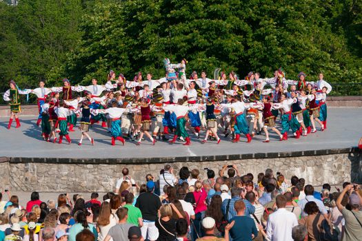 KIEV, UKRAINE - July 22 , 2016: Ukraina School of Dance Ensemble girls and boys dressed in traditional red Ukrainian embroidered costume clothes dancing