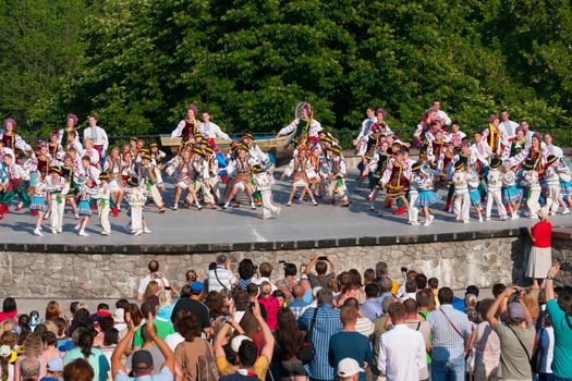 KIEV, UKRAINE - July 22 , 2016: Ukraina School of Dance Ensemble girls and boys dressed in traditional red Ukrainian embroidered costume clothes dancing