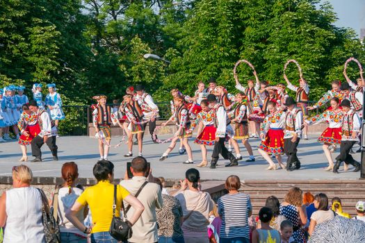 KIEV, UKRAINE - July 22 , 2016: Ukraina School of Dance Ensemble girls and boys dressed in traditional red Ukrainian embroidered costume clothes dancing