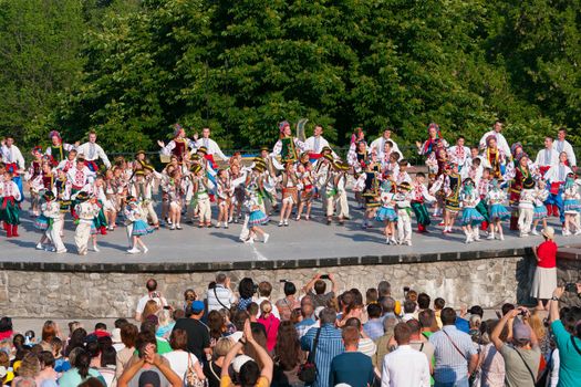 KIEV, UKRAINE - July 22 , 2016: Ukraina School of Dance Ensemble girls and boys dressed in traditional red Ukrainian embroidered costume clothes dancing