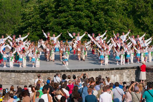 KIEV, UKRAINE - July 22 , 2016: Ukraina School of Dance Ensemble girls and boys dressed in traditional red Ukrainian embroidered costume clothes dancing