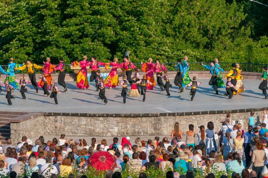 KIEV, UKRAINE - July 22 , 2016: Ukraina School of Dance Ensemble girls and boys dressed in traditional red Ukrainian embroidered costume clothes dancing