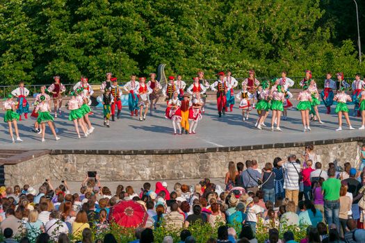 KIEV, UKRAINE - July 22 , 2016: Ukraina School of Dance Ensemble girls and boys dressed in traditional red Ukrainian embroidered costume clothes dancing