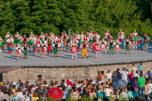 KIEV, UKRAINE - July 22 , 2016: Ukraina School of Dance Ensemble girls and boys dressed in traditional red Ukrainian embroidered costume clothes dancing