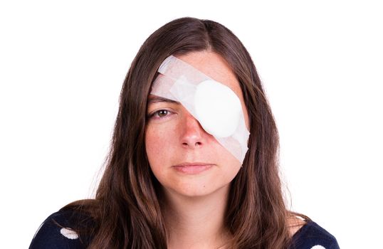 Portrait of woman wearing white eye patch as protection after injury