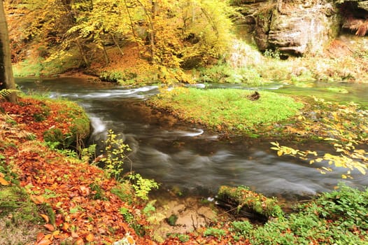 Autumn colored trees, leaves, rocks around the beautiful river