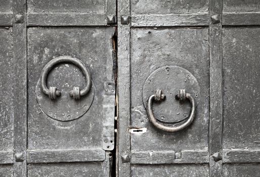 Ring-shaped door knocker on a metal gate