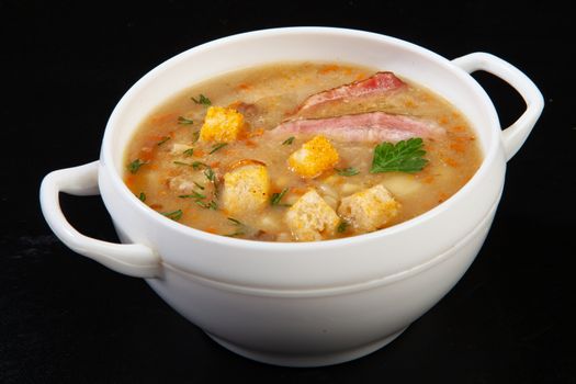 Porcelain plate with mushroom soup and beef