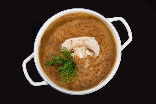 Porcelain plate with mushroom soup and beef