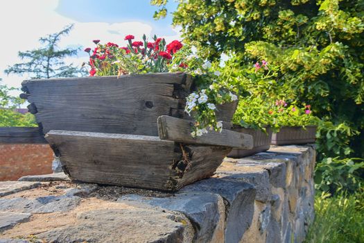 Old rustic wooden window box. Flowery background in Europe. Czech Republic, South Moravia. 