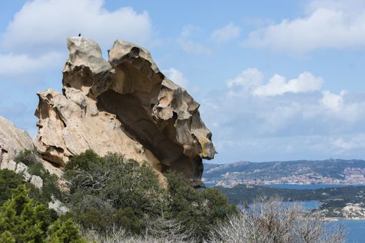 rocks and blue ocean seen from capo orso in sardinia italy, with la maddalena as background,capo dorso is a landmark wth beautifull rocks at the costa emeralda