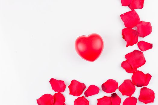 Heart and frame of artificial rose petals on white background