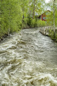 The Rapids at Renforsen in Vindeln, Sweden with old mill.