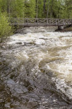 The rapids at Renforsen in Vindeln, Sweden with a wooden bridge.