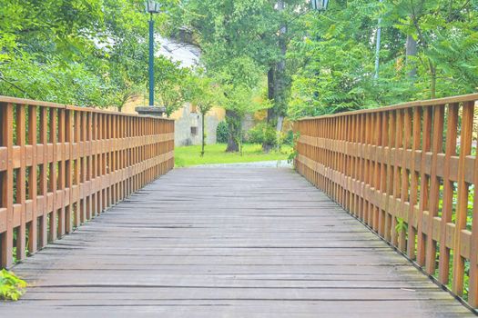 Old wooden bridge in town, natural vintage background.