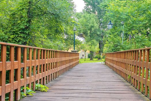 Old wooden bridge in town, natural vintage background.