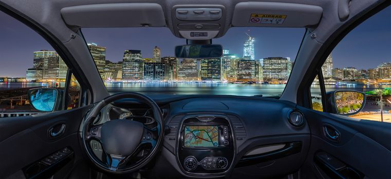 Looking through a car windshield with view over Manhattan skyline at night, New York City, USA