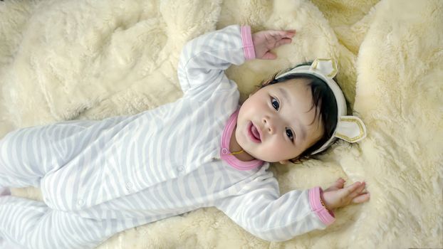 Asian cute baby girl lying on the bed