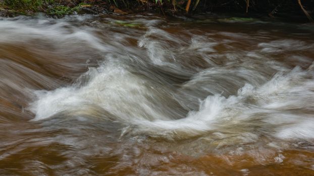 rough water in the mountain river water as a background