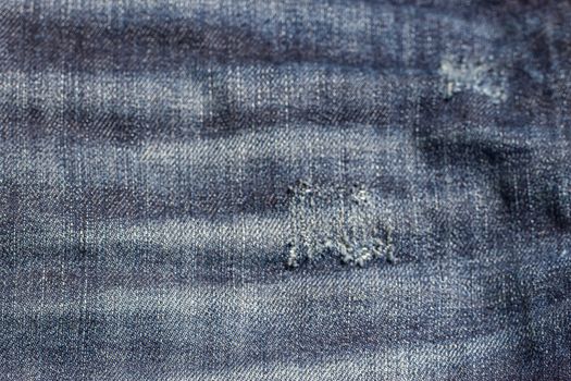 the blue Jeans torn denim texture with hole