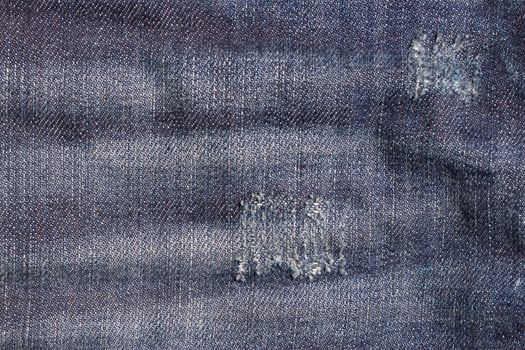 the blue Jeans torn denim texture with hole