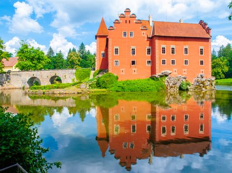 Water castle Cervena Lhota reflected in the water. Southern Bohemia, Czech Republic.