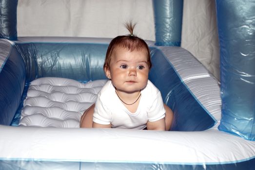 little girl in inflatable mattress